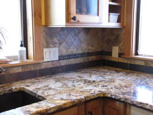 Custom backsplash with tumbled marble stone tile and slate tile